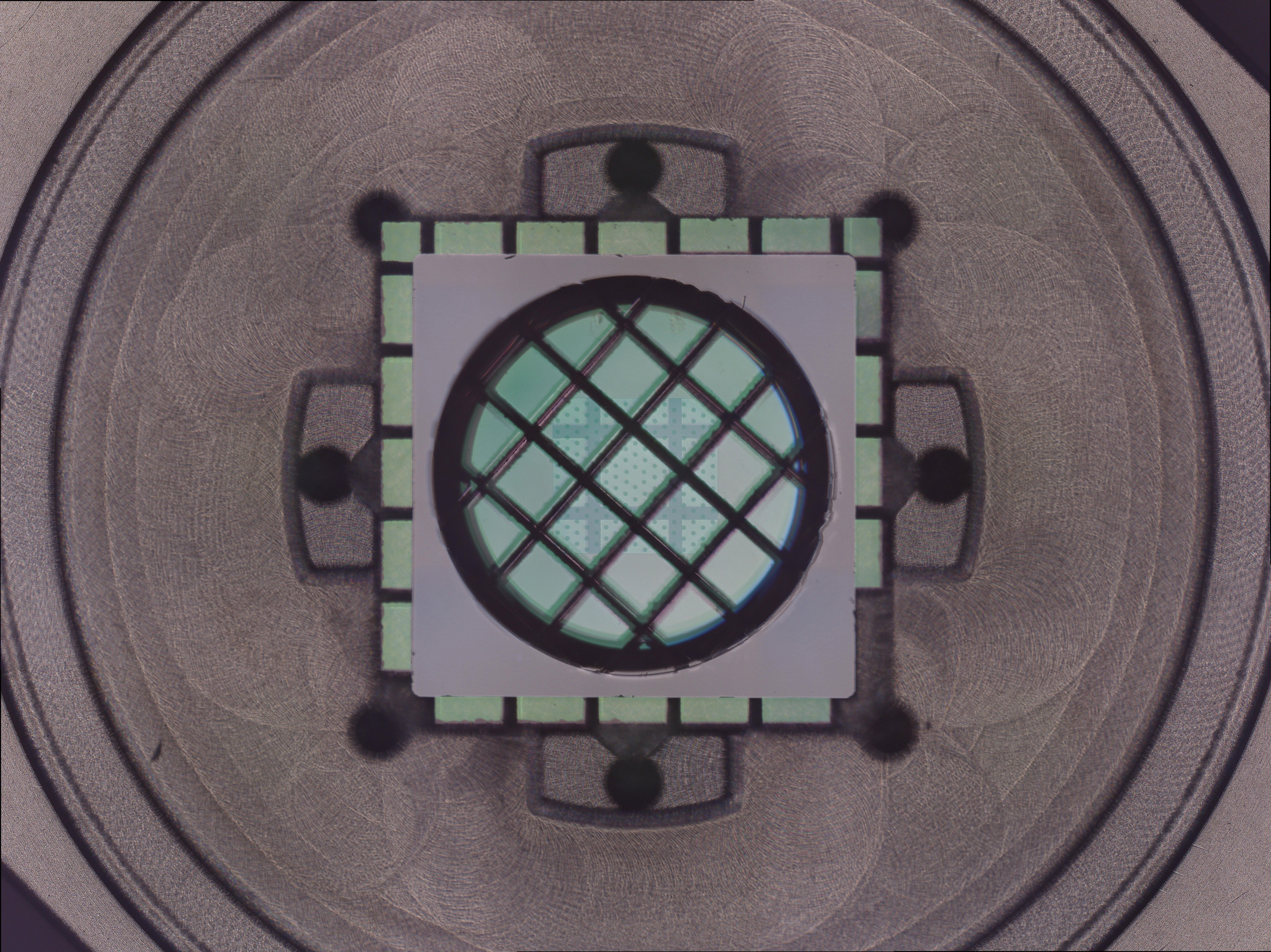 A grey machinery with a square block that has grid like structure where the ligh foes through A grey machinery with a square block that has grid like structure where the ligh foes through