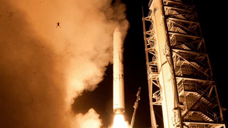 a rocket launching, there's fire and smoke, and the silhouette of a frog being thrown into the air